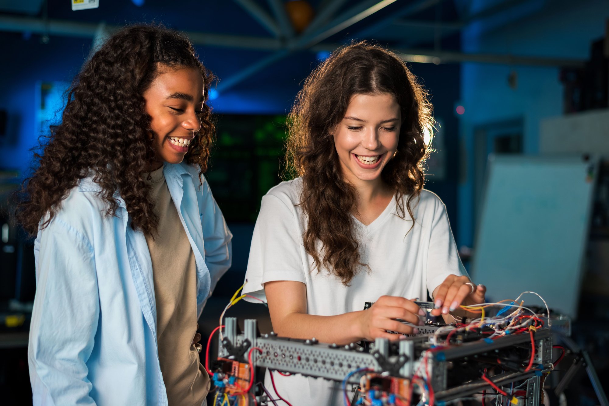 two-young-women-doing-experiments-in-robotics-in-a-2023-11-27-05-33-47-utc