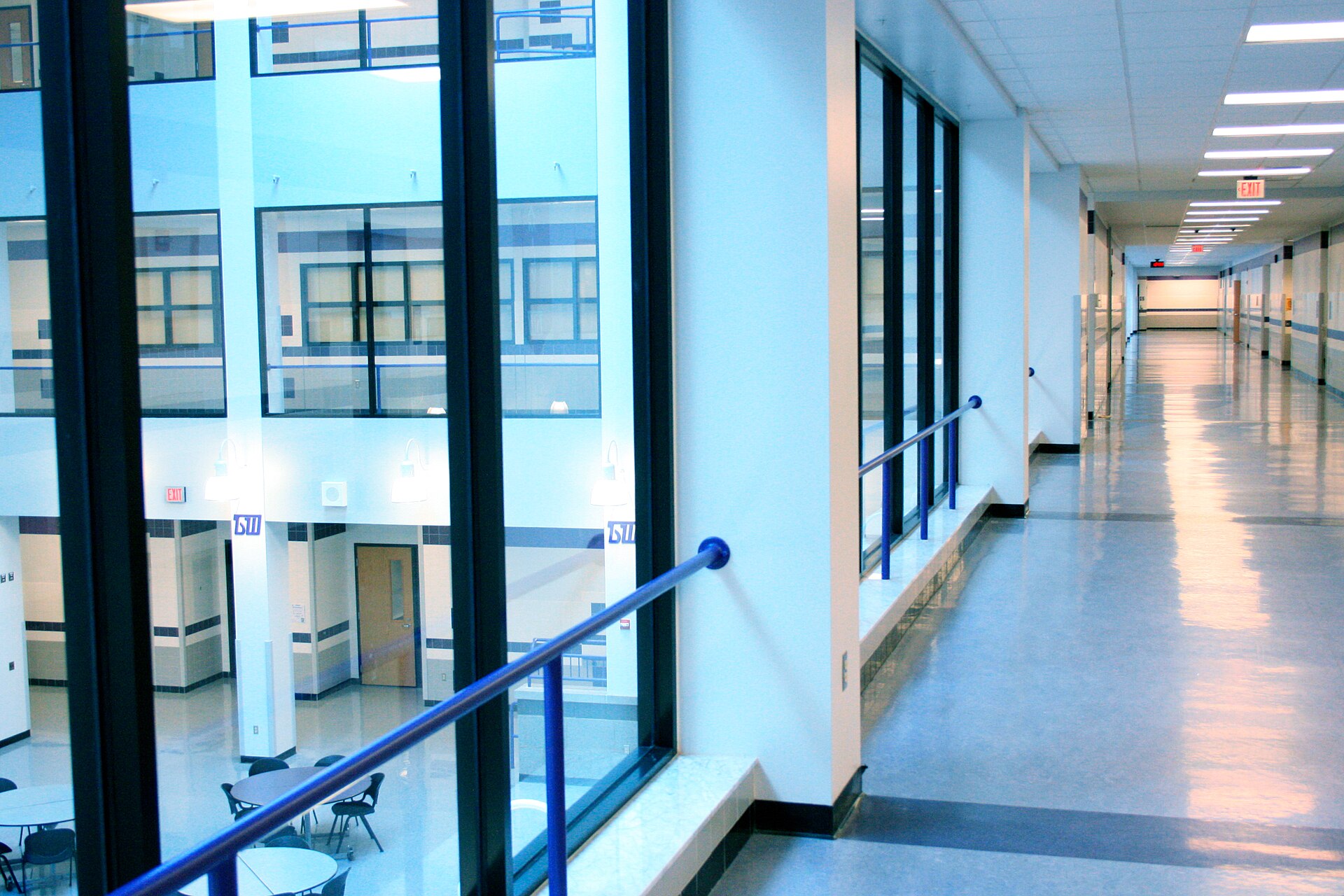 Empty modern high school hallway with polished tile floor
