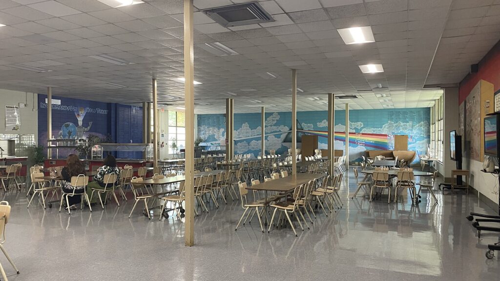Empty US high school cafeteria after hours with polished tile floor